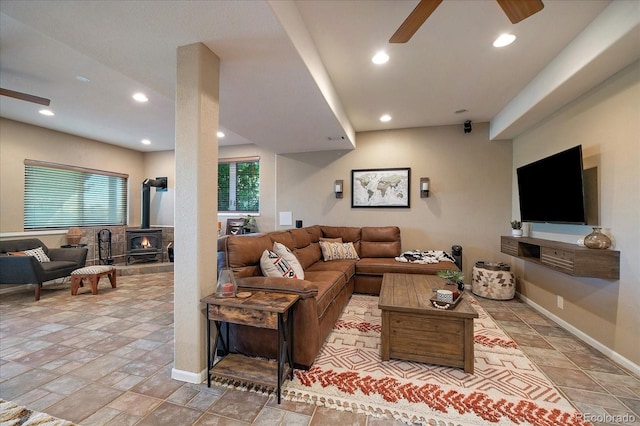 1248 Rawhide Cir, Elizabeth, CO 80107 - living room with ceiling fan, a wood stove, stone tile flooring, and recessed lighting