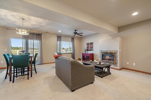 1248 Rawhide Cir, Elizabeth, CO 80107 - living room with light carpet, a chandelier, a ceiling fan, a glass covered fireplace, and recessed lighting