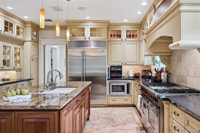 6300 E 17th Avenue Parkway, Denver, CO 80220 - kitchen with a sink, built in appliances, cream cabinetry, and recessed lighting