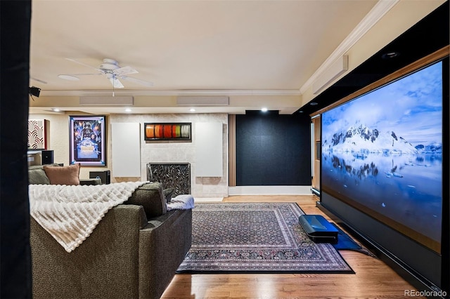 6300 E 17th Avenue Parkway, Denver, CO 80220 - cinema room featuring a tiled fireplace, ornamental molding, wood finished floors, a ceiling fan, and baseboards