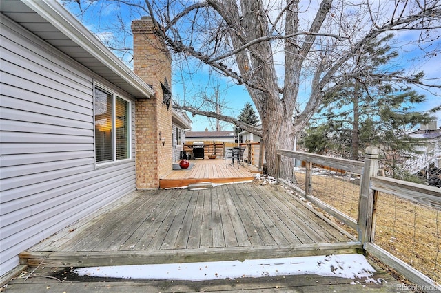 wooden terrace featuring area for grilling