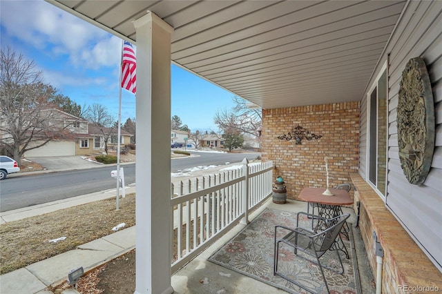 balcony featuring a porch and a residential view