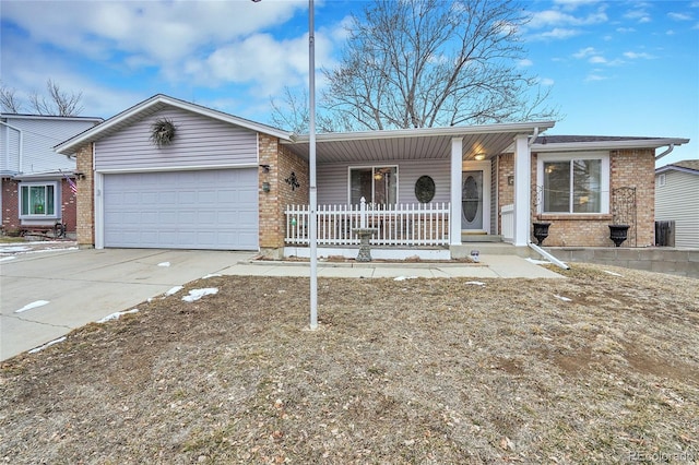 ranch-style home with driveway, covered porch, an attached garage, and brick siding