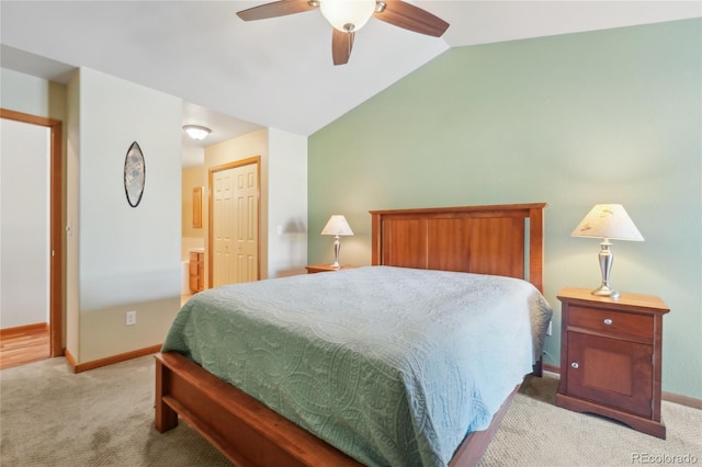 carpeted bedroom with ceiling fan, a closet, and vaulted ceiling