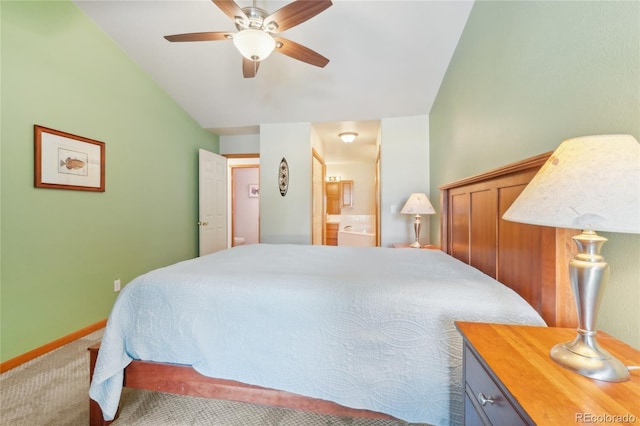 bedroom featuring carpet floors, connected bathroom, vaulted ceiling, and ceiling fan