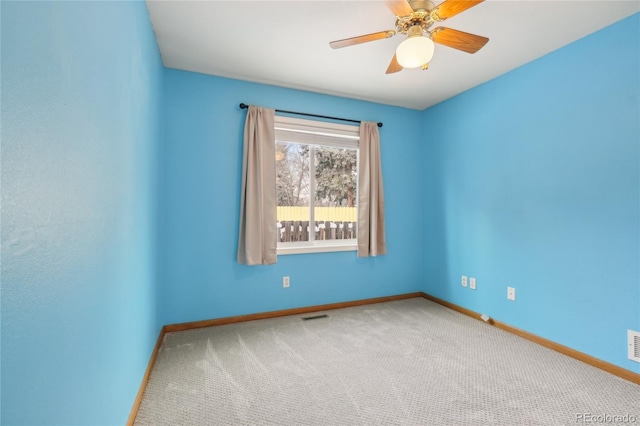 carpeted spare room with ceiling fan