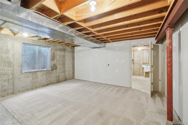 basement with light carpet and sink