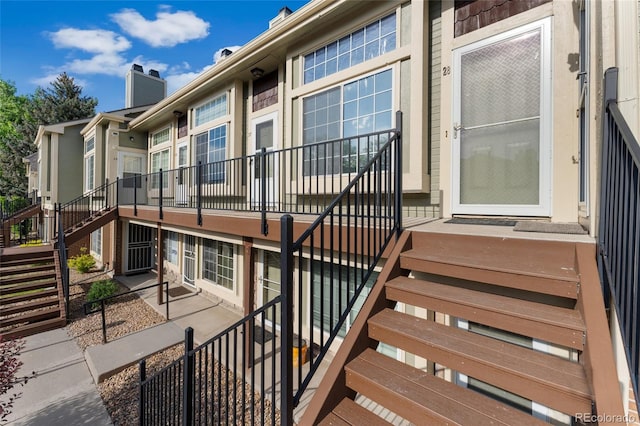 1885 S Quebec Way Unit A28, Denver, CO 80231 - view of exterior entry with a chimney and a patio area