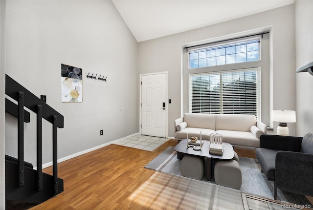 1885 S Quebec Way Unit A28, Denver, CO 80231 - living room with wood finished floors, high vaulted ceiling, and baseboards