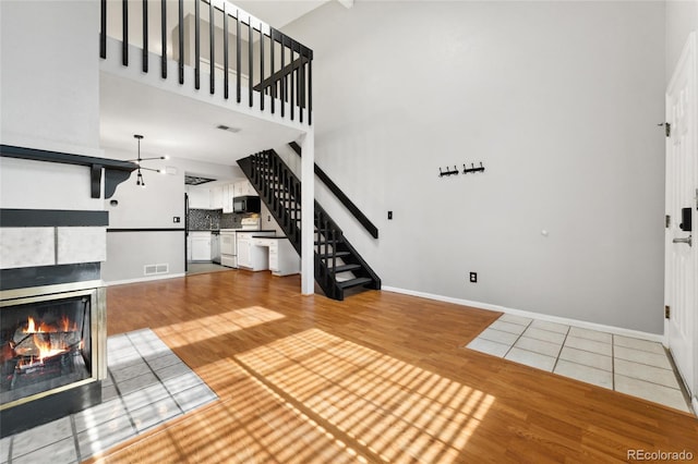 1885 S Quebec Way Unit A28, Denver, CO 80231 - unfurnished living room with stairway, wood finished floors, a fireplace, and baseboards