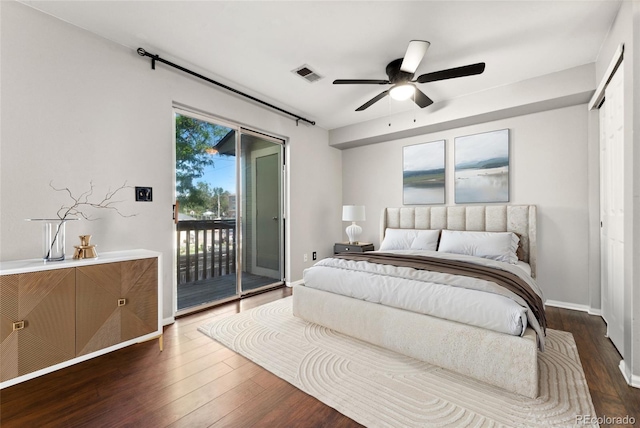 1885 S Quebec Way Unit A28, Denver, CO 80231 - bedroom with access to outside, dark wood finished floors, baseboards, and a ceiling fan