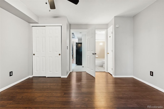 1885 S Quebec Way Unit A28, Denver, CO 80231 - unfurnished bedroom featuring wood finished floors, baseboards, a closet, ensuite bath, and ceiling fan