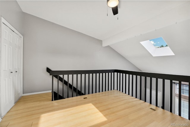 1885 S Quebec Way Unit A28, Denver, CO 80231 - hall featuring a skylight, an upstairs landing, wood finished floors, and baseboards