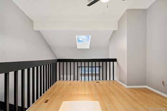 1885 S Quebec Way Unit A28, Denver, CO 80231 - corridor with lofted ceiling, a skylight, wood finished floors, and baseboards