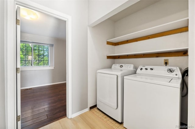 1885 S Quebec Way Unit A28, Denver, CO 80231 - laundry room with washing machine and clothes dryer, baseboards, and light wood-type flooring