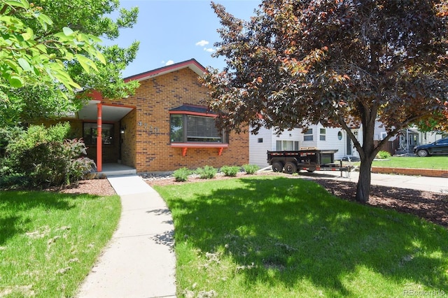 4720 S Grant St, Englewood, CO 80113 - obstructed view of property with brick siding and a front lawn