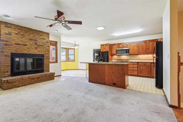 4720 S Grant St, Englewood, CO 80113 - kitchen featuring black appliances, open floor plan, light colored carpet, a ceiling fan, and brown cabinetry
