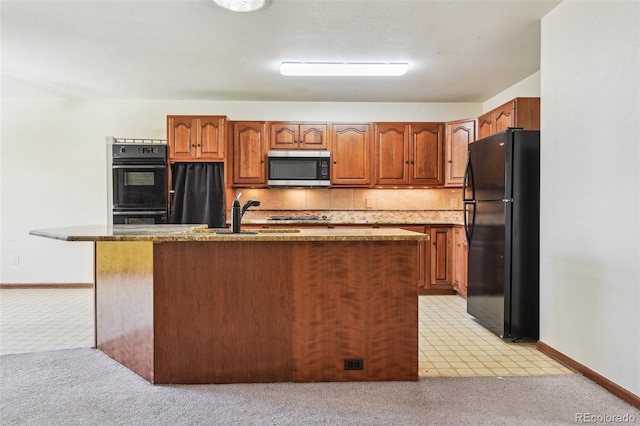 4720 S Grant St, Englewood, CO 80113 - kitchen with black appliances, light carpet, backsplash, and stone counters