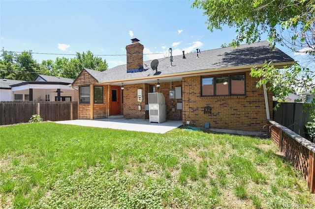4720 S Grant St, Englewood, CO 80113 - back of house featuring a chimney, a patio, a fenced backyard, and brick siding