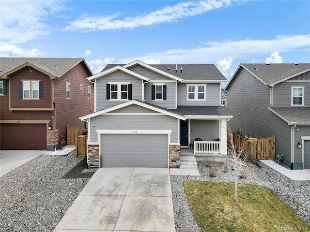 craftsman inspired home featuring concrete driveway, a garage, a porch, and fence