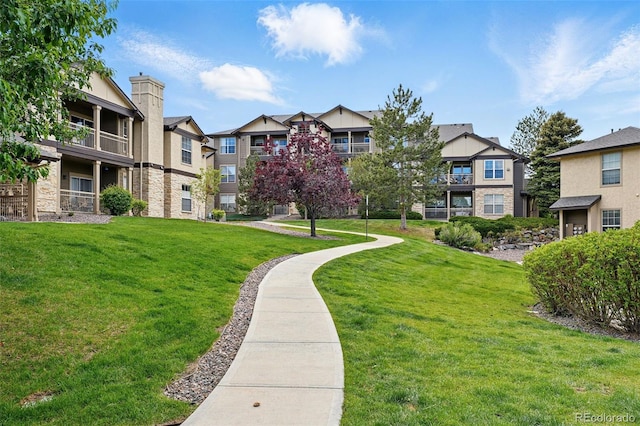 view of community featuring a yard and a residential view