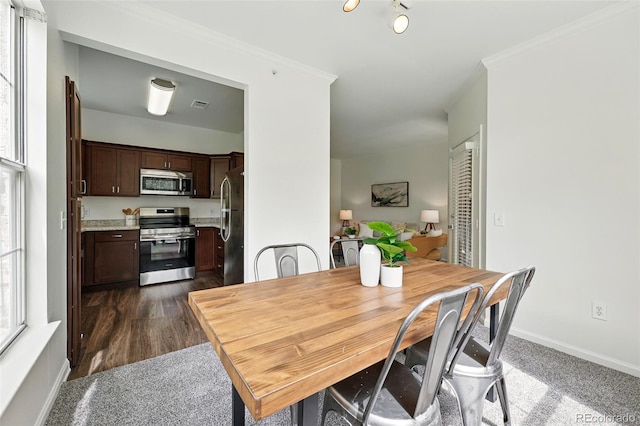 dining room with crown molding and baseboards