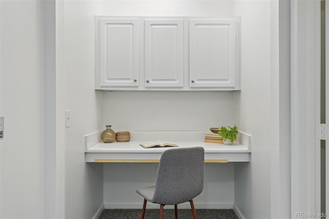 office featuring built in desk and baseboards
