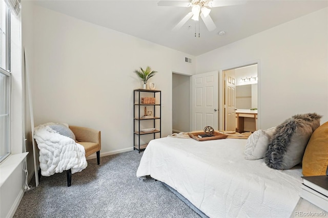 bedroom with carpet flooring, baseboards, connected bathroom, and a ceiling fan