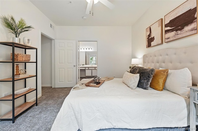 carpeted bedroom featuring ensuite bathroom and a ceiling fan