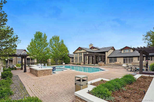 view of pool with a pergola, a patio area, and a pool with connected hot tub