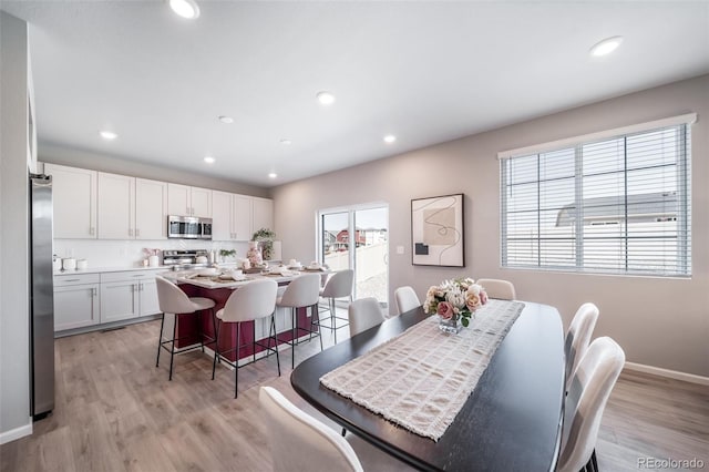 3879 N Shawnee St, Aurora, CO 80019 - dining area featuring light wood-type flooring, baseboards, and recessed lighting