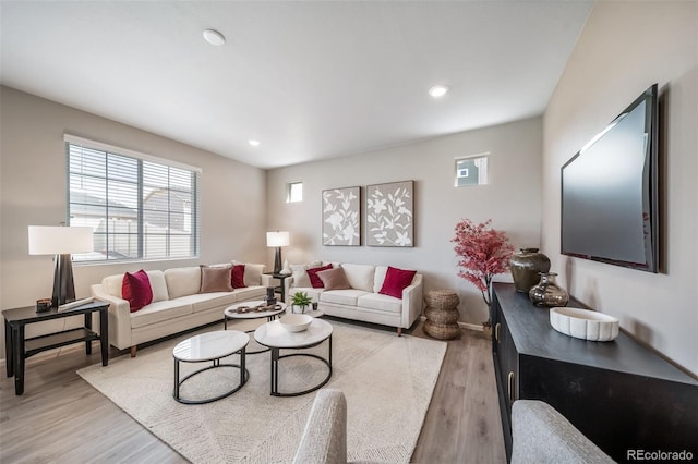 3879 N Shawnee St, Aurora, CO 80019 - living area with light wood finished floors, recessed lighting, and baseboards