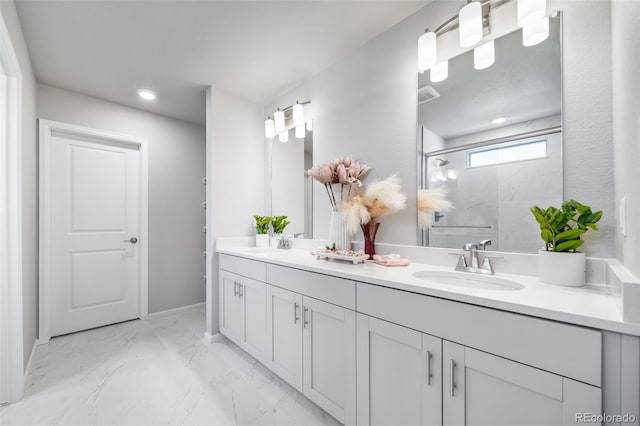 3879 N Shawnee St, Aurora, CO 80019 - bathroom featuring double vanity, a marble finish shower, marble finish flooring, recessed lighting, and baseboards