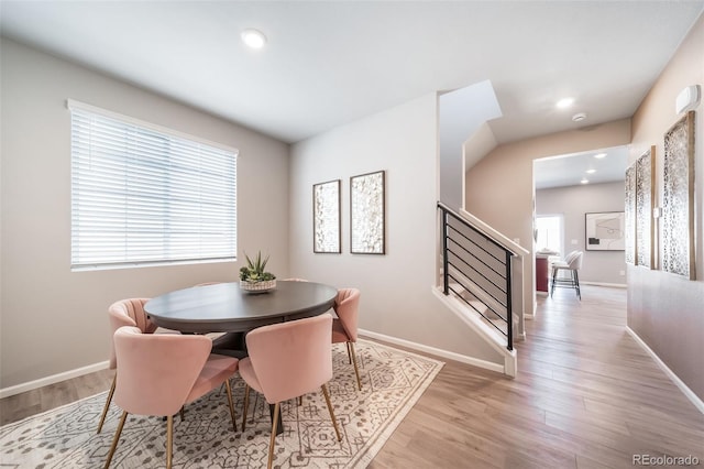 3879 N Shawnee St, Aurora, CO 80019 - dining room with light wood-type flooring, stairway, baseboards, and recessed lighting