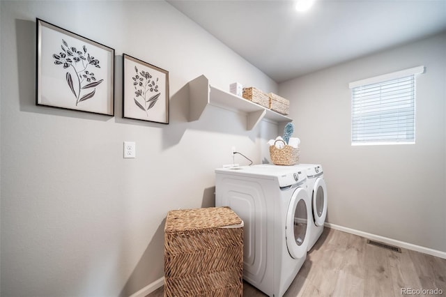 3879 N Shawnee St, Aurora, CO 80019 - washroom featuring separate washer and dryer, baseboards, and light wood-style floors