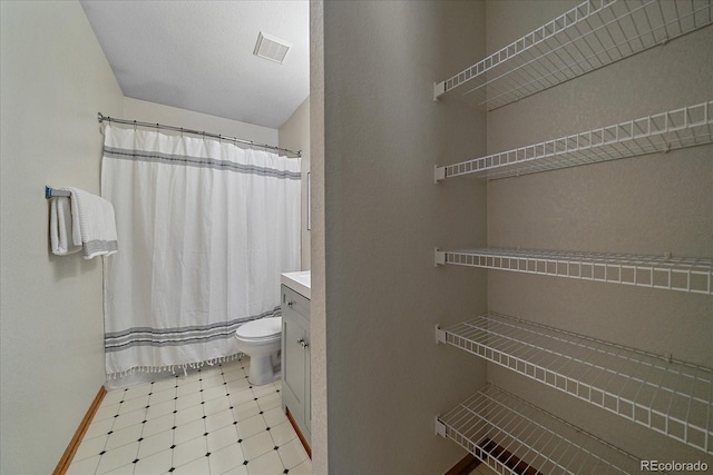 bathroom featuring tile patterned floors, vanity, toilet, and a shower with shower curtain