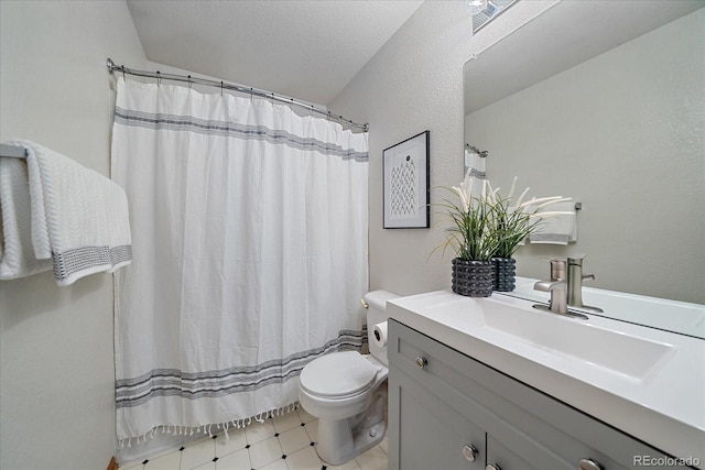 bathroom with a shower with curtain, a textured ceiling, vanity, tile patterned flooring, and toilet