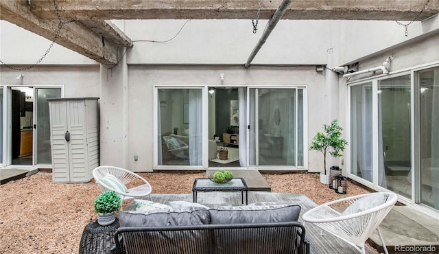 rear view of property with a patio, stucco siding, and an outdoor living space
