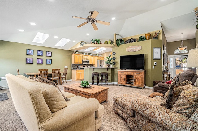 living room with ceiling fan and lofted ceiling