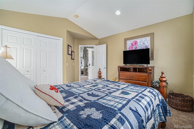 carpeted bedroom with vaulted ceiling and a closet