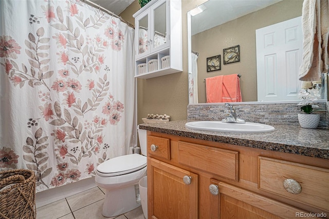 bathroom featuring tile patterned flooring, vanity, and toilet