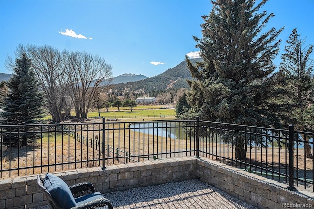 balcony featuring a water and mountain view