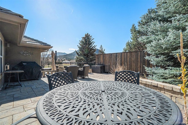 view of patio / terrace with a mountain view and a grill