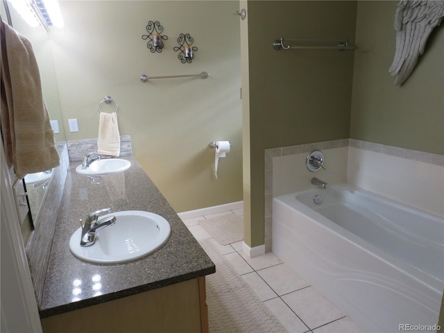 bathroom featuring vanity, tile patterned floors, and a bathing tub