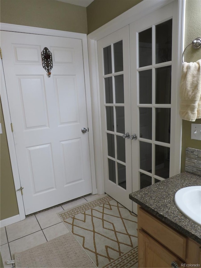 doorway featuring light tile patterned floors and sink