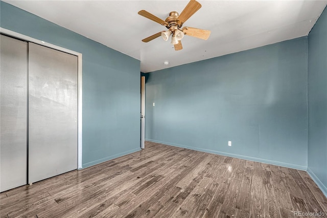 7541 Julian St, Westminster, CO 80030 - unfurnished bedroom with wood finished floors, a closet, baseboards, and ceiling fan
