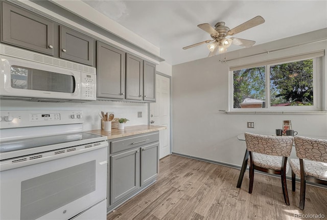 7541 Julian St, Westminster, CO 80030 - kitchen featuring white appliances, gray cabinets, light wood-style floors, ceiling fan, and light countertops