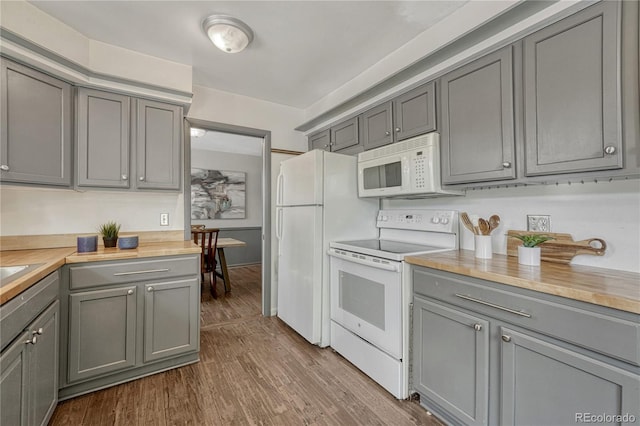 7541 Julian St, Westminster, CO 80030 - kitchen with white appliances, gray cabinets, dark wood-style floors, and wood counters