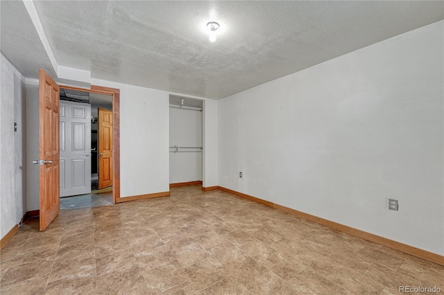 7541 Julian St, Westminster, CO 80030 - unfurnished bedroom with baseboards, a closet, and a textured ceiling