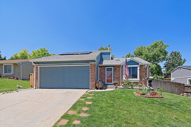 6085 S Parfet St, Littleton, CO 80127 - ranch-style house with an attached garage, concrete driveway, solar panels, brick siding, and a shingled roof